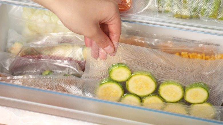 Putting vacuum bag with zucchini in fridge