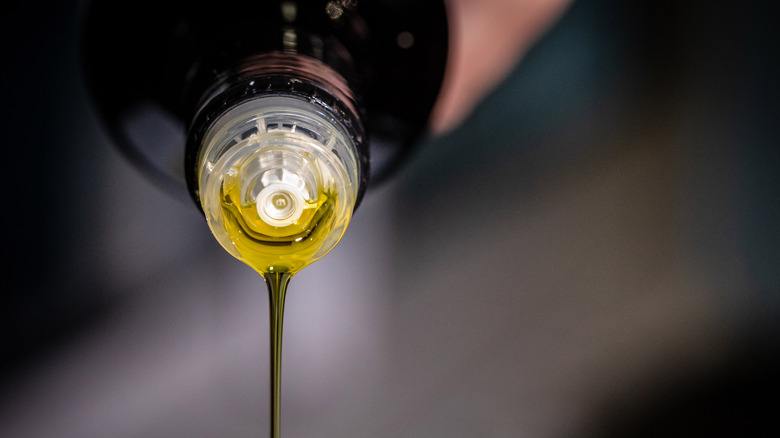 pouring bottle of olive oil