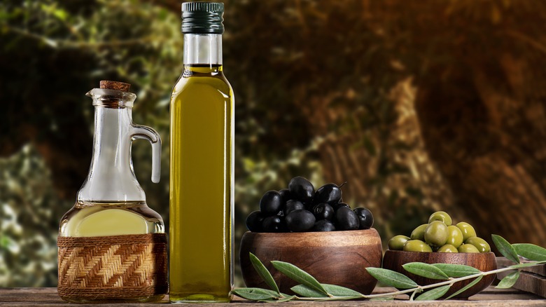 bottles of olive oil and bowls of olives