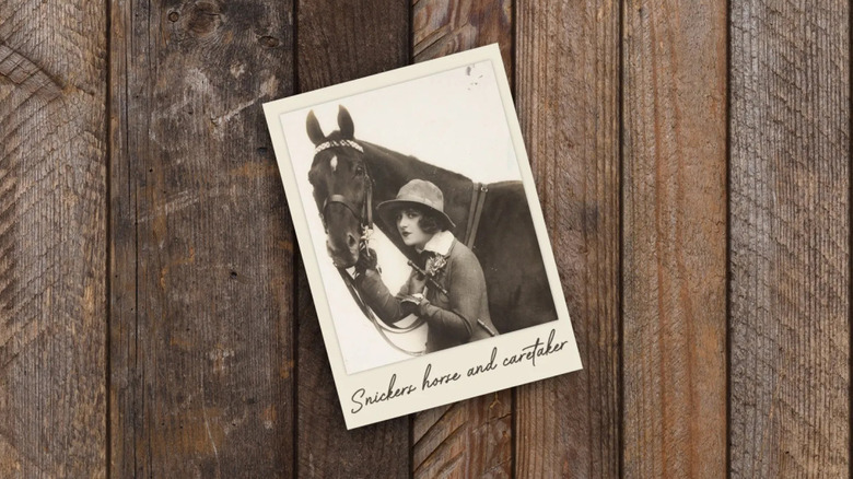 a photo of a polaroid with the Snickers horse and a woman who was the horse's caretaker