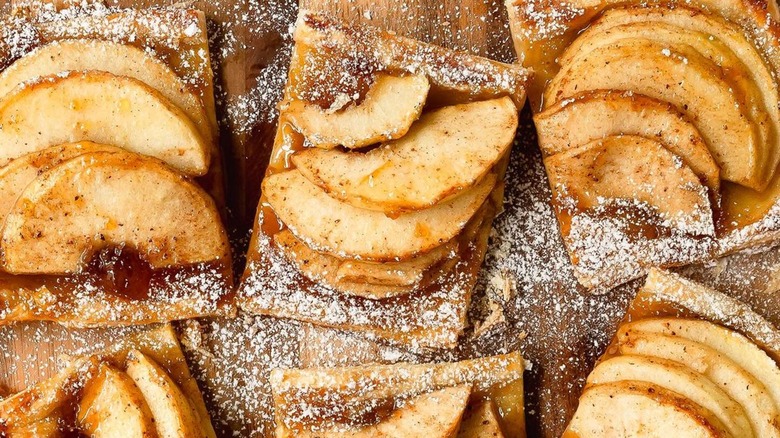 Close-up photo of cinnamon apple tarts with powdered sugar