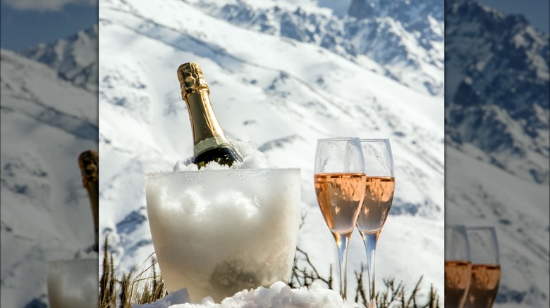 Bottle of champagne mountainous background.