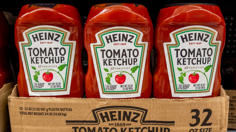 3 bottles of Heinz ketchup in a box.