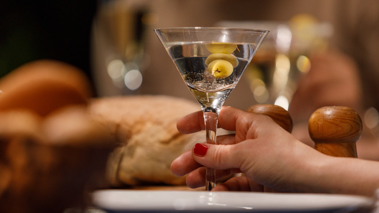 Hand holding a martini