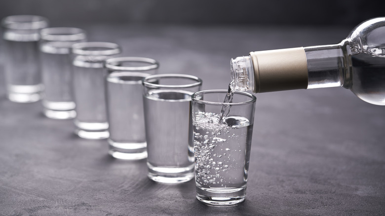 Pouring vodka into shot glasses