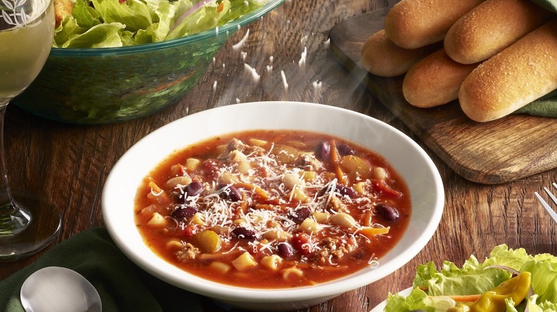 Olive Garden grated cheese sprinkling onto a bowl of soup