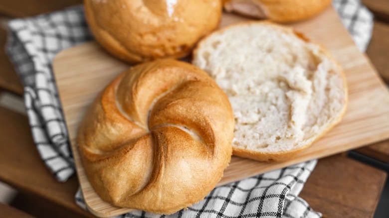 Kaiser rolls on cutting board