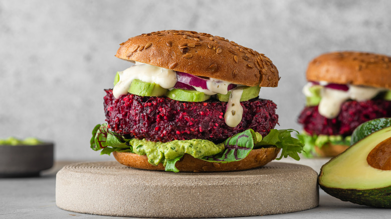 A beet-based veggie burger on a stone slab.