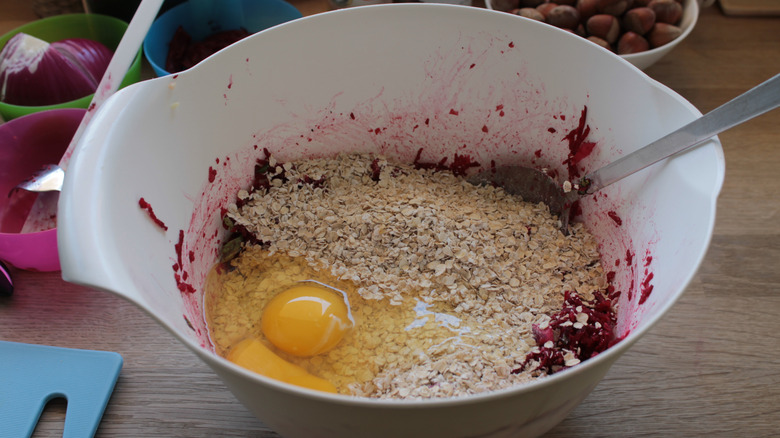 Egg being mixed into a veggie burger recipe.