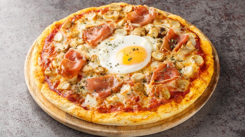 pizza with egg, guanciale, and mushrooms