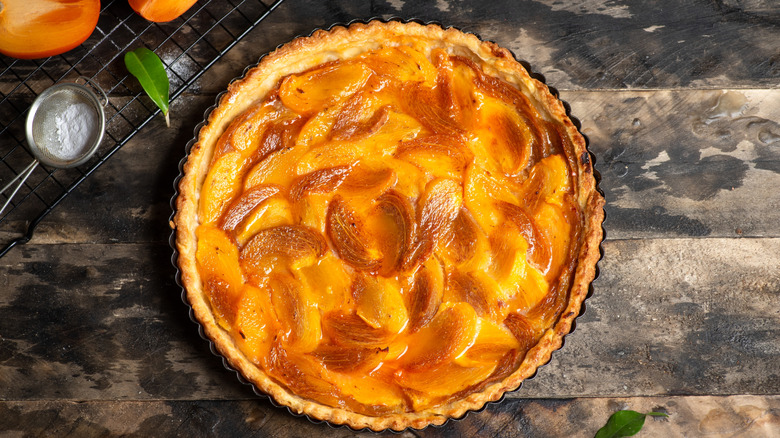 caramelized persimmon tart in pie pan on counter