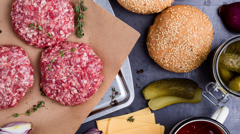 Burger ingredients spread out on counter