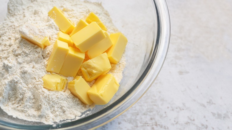 Cubed butter in a bowl of flour