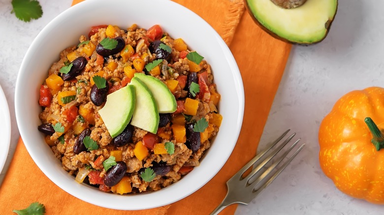 Pumpkin chili garnished with avocado