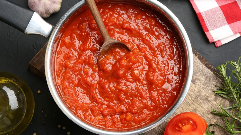 Stirring marinara sauce in pot