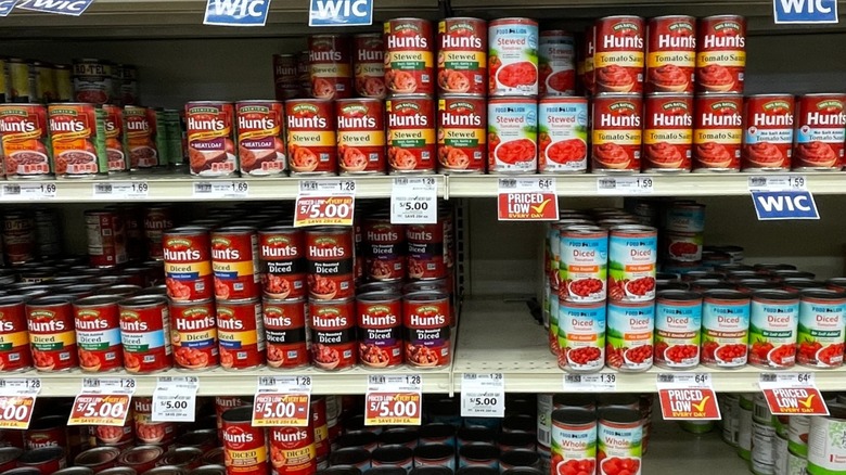 A row of canned tomatoes at the supermarket