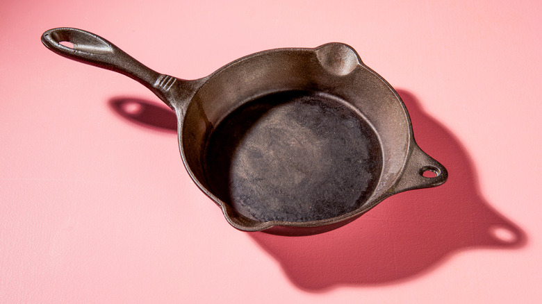 cast iron pan against pink background