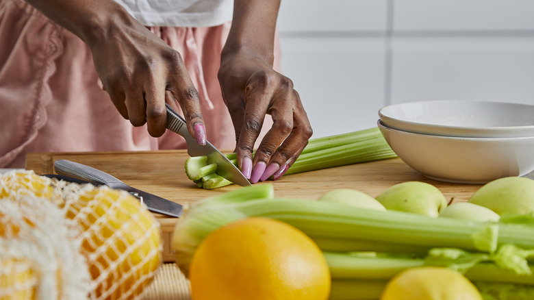 Person chopping celery