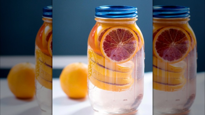 Preserving jar containing blood orange infused vodka