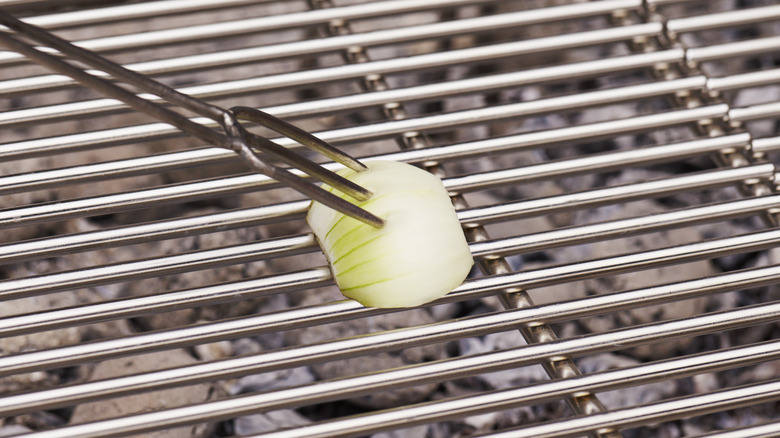 clean grill with half white onion