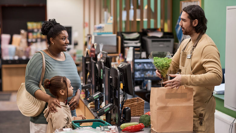 Parent and child at grocery checkout