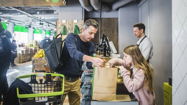 Parent and child at grocery checkout