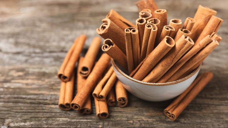 cinnamon sticks in a bowl on a table