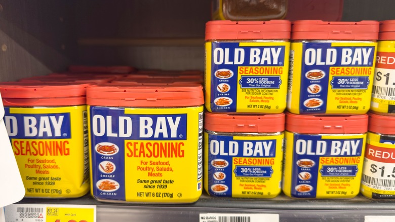 Tins of Old Bay seasoning on a grocery store shelf.