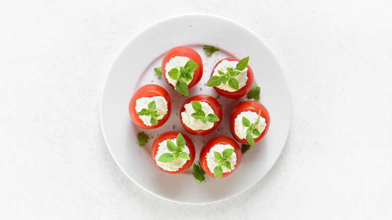 plate of cherry tomatoes stuffed with burrata