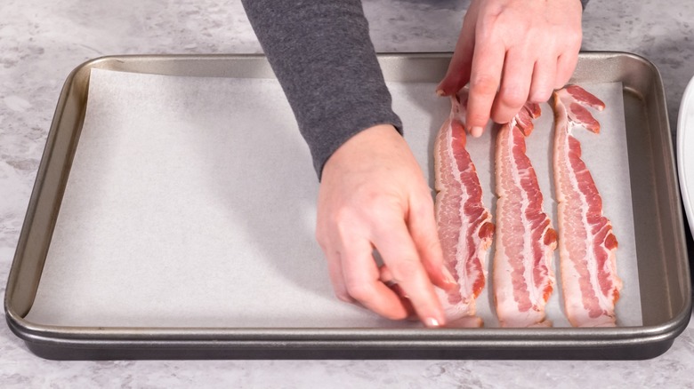 putting bacon on parchment paper