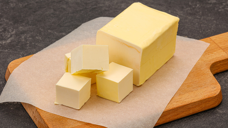 butter cubed on a wood board