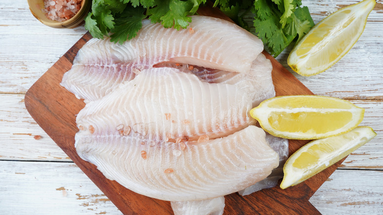 Tilapia fillets on a cutting board