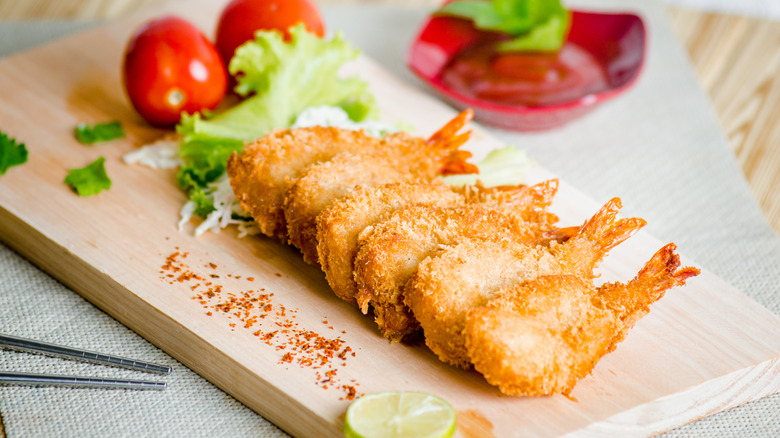 Butterflied fried shrimp on board