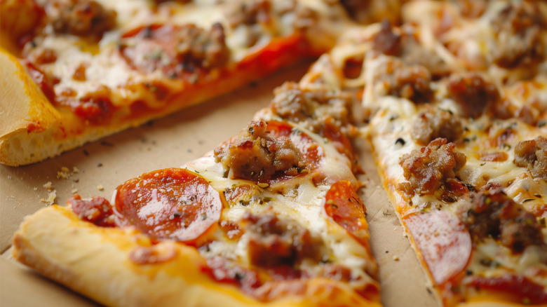 up close of pepperoni and sausage pizza slices