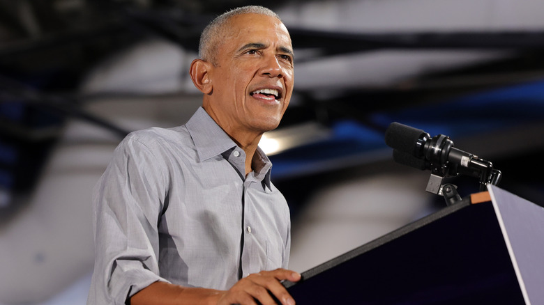 Barack Obama stands speaking at a podium