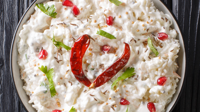 A bowl of curd rice with chilies