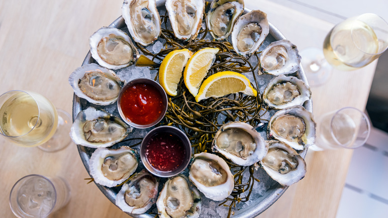 Oysters with lemons, sauce, and champagne