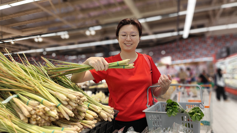 Asian woman holding lemongrass