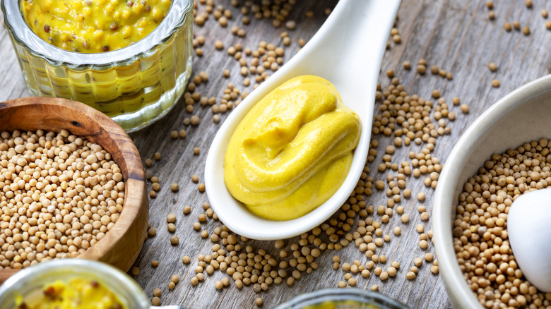 Dijon mustard surrounded by mustard seeds