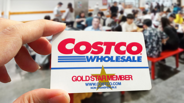 Hand holding up a Costco Goldstar member card