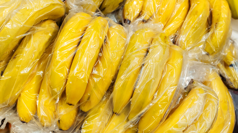 Dozens of bananas in plastic bags