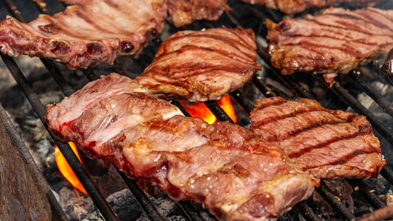 pork steaks cooking on grill