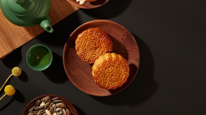 Pumpkin mooncakes on a wooden plate