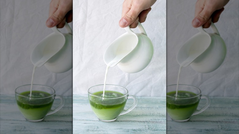 Person pouring creamer into matcha