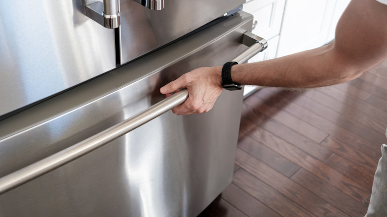 man opening a home freezer