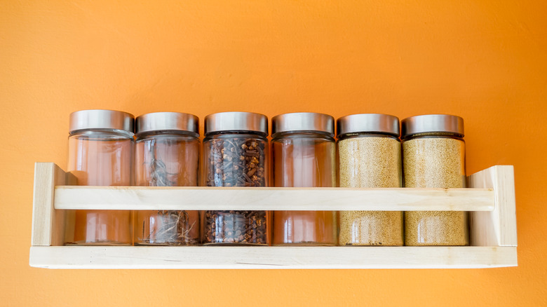 spice jars on yellow background