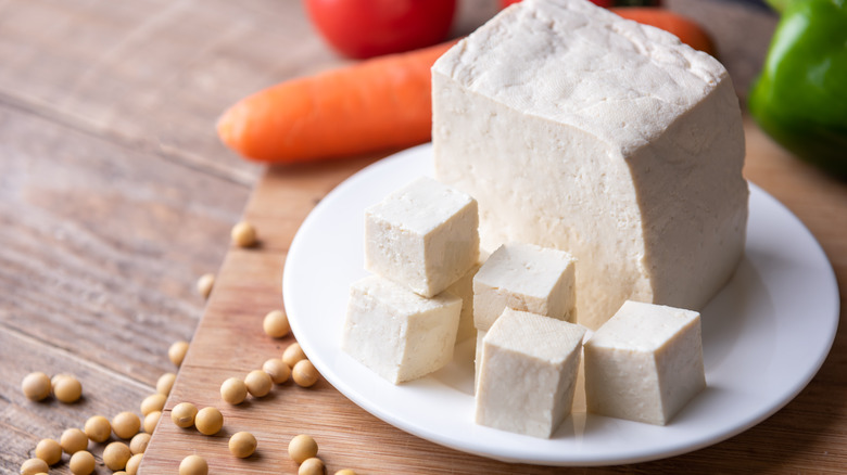 cubed tofu next to vegetables