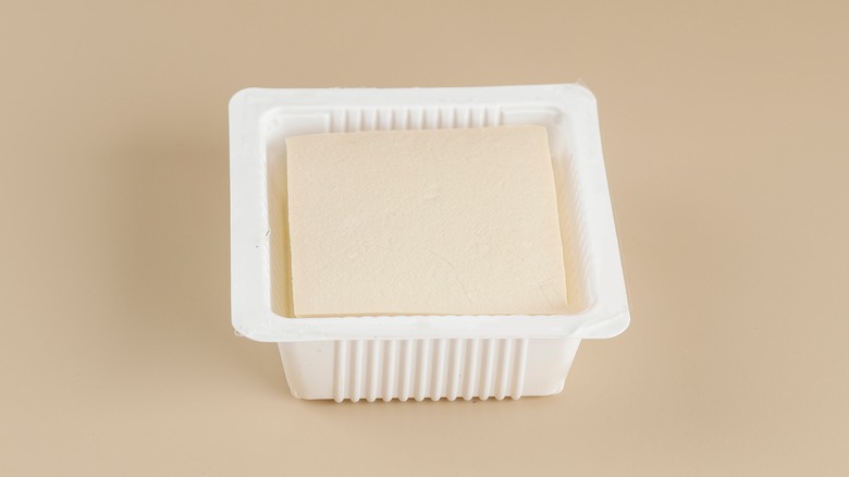 tofu sitting in plastic package with water