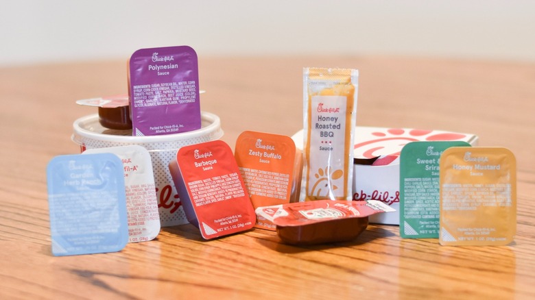 A collection of all Chick-fil-A dipping sauces on a wooden table