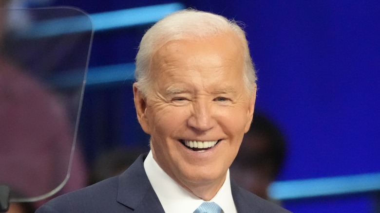 President Joe Biden smiling while giving a speech